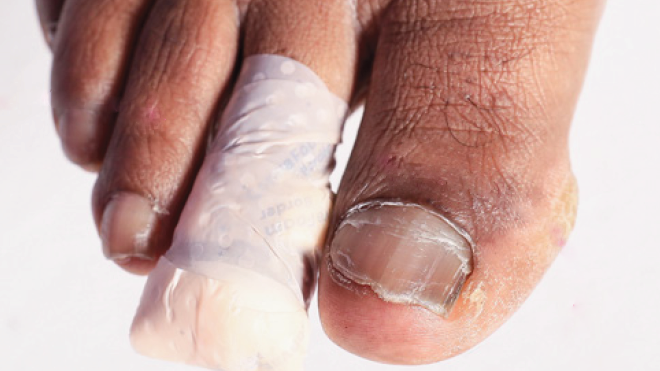 a close-up of a person's hand holding a small object